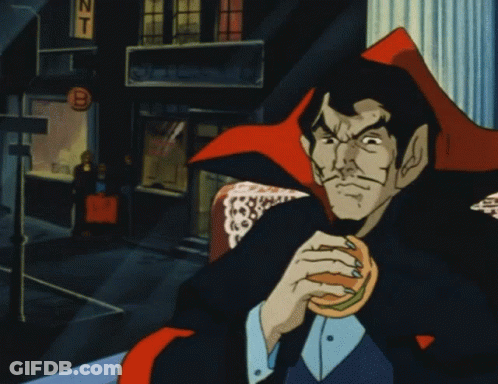 Man In Vampire Costume Eating Hamburger GIF