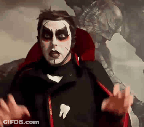 Man In Vampire Costume With Tooth Shirt GIF