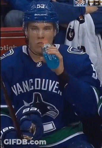 Man In Vancouver Jersey Drinking Blue Bottle GIF