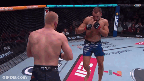Man In Venum Shorts In Cage GIF