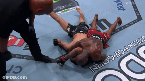 Man In Venum Shorts Laying On Ground GIF