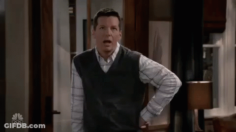 Man In Vest And Plaid Shirt Hands On Hips GIF