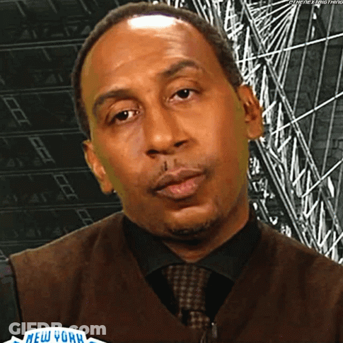 Man In Vest And Tie Before New York Sign GIF