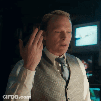 Man In Vest And Tie Holding Hand To Ear GIF