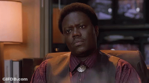 Man In Vest And Tie Sitting Before Television GIF