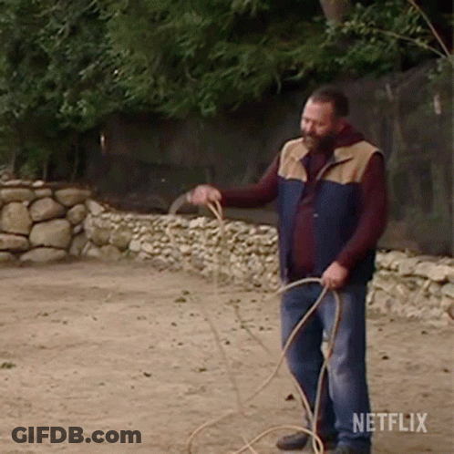 Man In Vest Holding Rope With Netflix Logo GIF