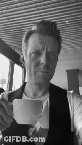 Man In Vest Holding White Cup Of Coffee GIF