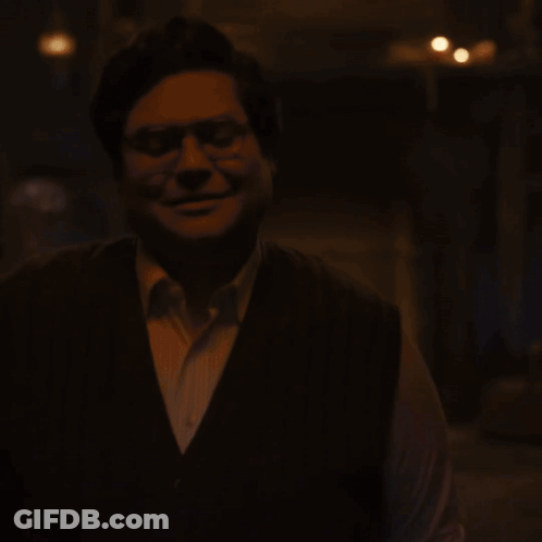 Man In Vest Looking Down GIF