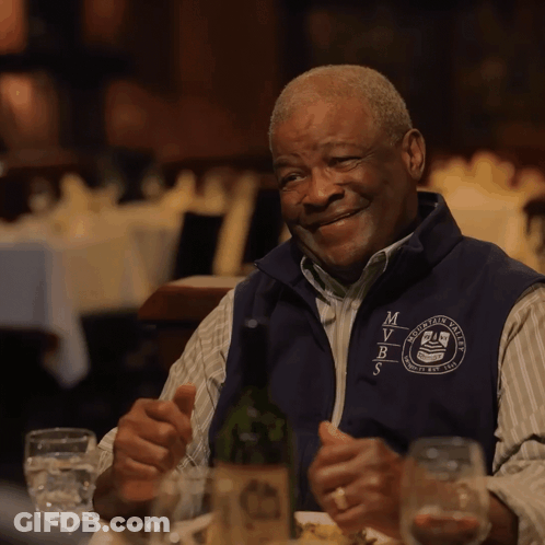 Man In Vest Saying MVRS Sitting At Table GIF