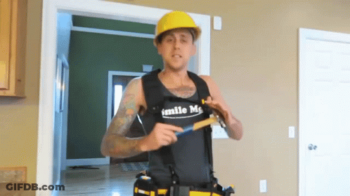 Man In Vest Saying Smile Me Holding Hammer GIF