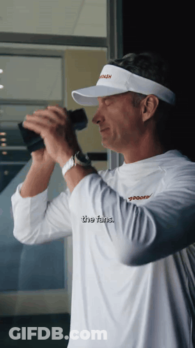 Man In Visor Saying Coach Looks Through Binoculars GIF