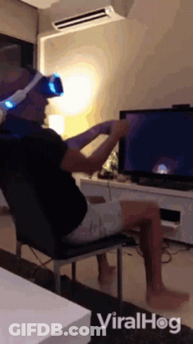 Man In VR Headset In Front Of TV GIF
