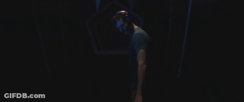 Man In VR Headset Walking Through Dark Tunnel GIF