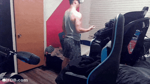 Man In VR Headset With Blue Chair GIF