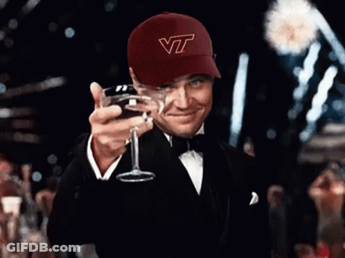 Man In VT Hat Holding Glass Of Wine GIF