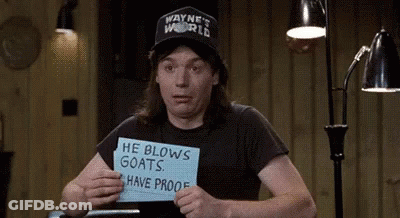 Man In Wayne's World Hat Holding He Blows Goats Have Proof Sign GIF