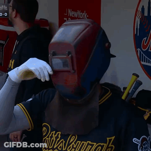 Man In Welding Helmet And Gloves With New York Sign GIF