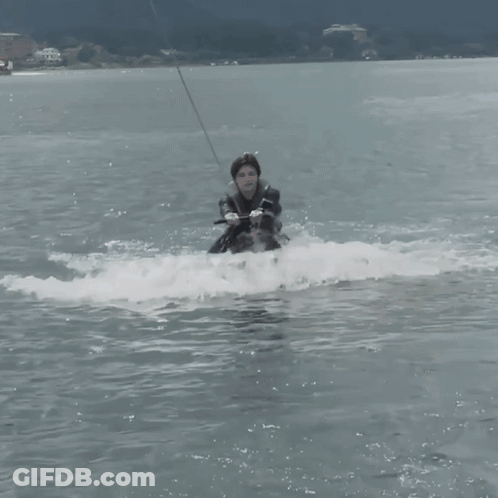 Man In Wetsuit Riding Wakeboard GIF