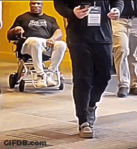 Man In Wheelchair Being Pushed GIF
