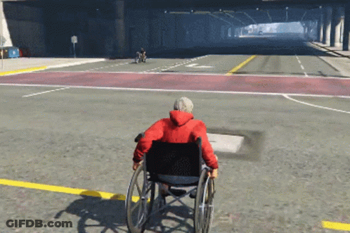 Man In Wheelchair Driving Down Street GIF