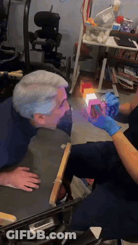 Man In Wheelchair Examined By Nurse With Gloves GIF
