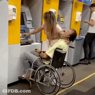 Man In Wheelchair Helped By Woman At ATM GIF