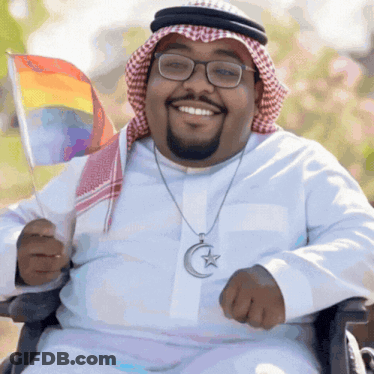 Man In Wheelchair Holding Rainbow Flag GIF
