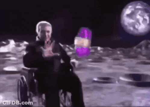 Man In Wheelchair On Moon Holding Purple Object GIF