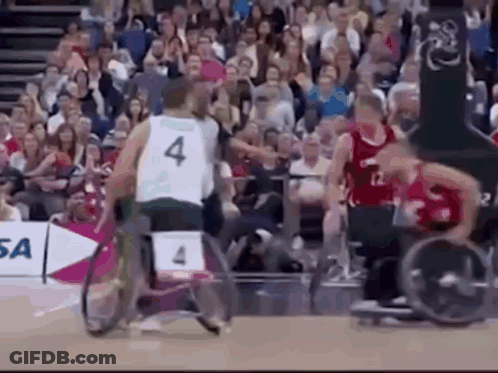 Man In Wheelchair Playing Basketball With Number 4 Jersey GIF
