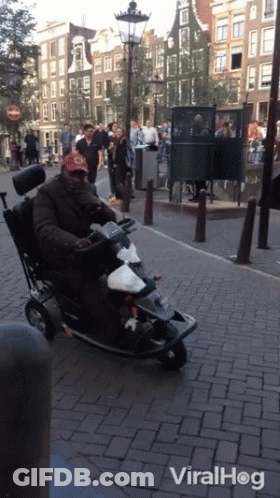 Man In Wheelchair Riding Mobility Scooter With Viralhog GIF