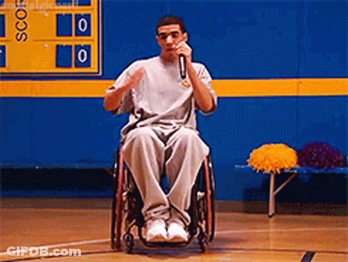Man In Wheelchair Speaking Into Microphone GIF