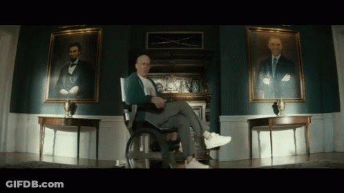 Man In Wheelchair With Two Abraham Lincoln Portraits GIF