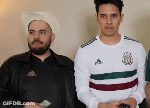 Man In White Adidas Shirt Next To Man In Cowboy Hat GIF