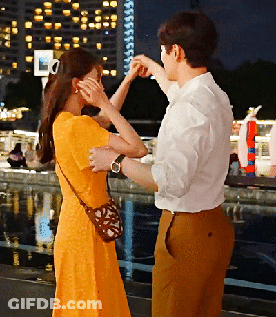 Man In White And Brown Dancing With Woman In Orange GIF