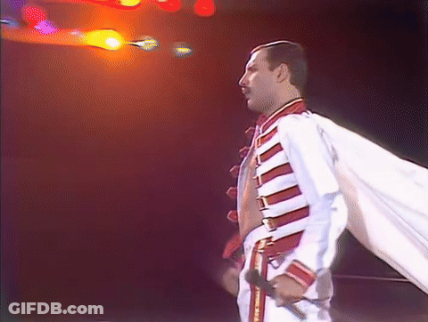 Man In White And Red Jacket Holding Microphone GIF