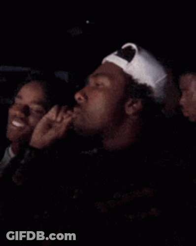 Man In White Baseball Cap Sitting Next To Woman GIF