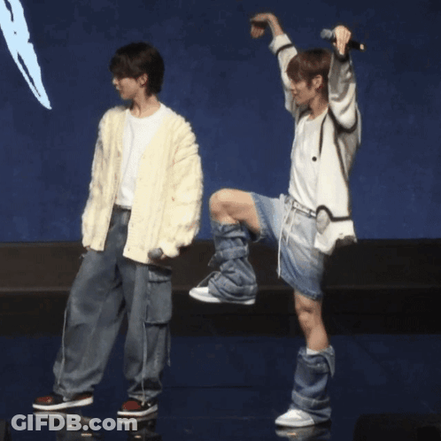 Man In White Cardigan Next To Man In White Shirt GIF
