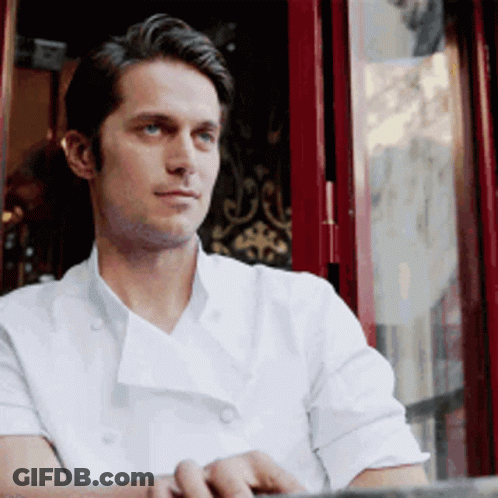 Man In White Chef Coat Sitting By Window GIF