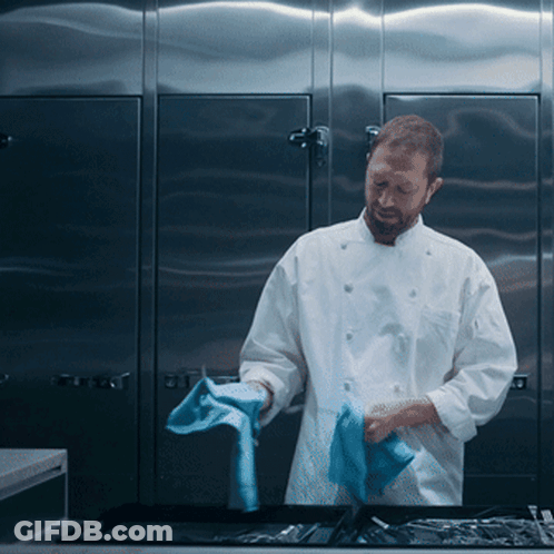 Man In White Chef Uniform Cleaning Tray With Blue Cloth GIF