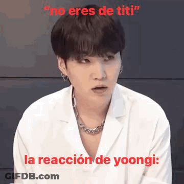 Man In White Coat And Necklace Making Funny Face Saying No Eres De Titi GIF