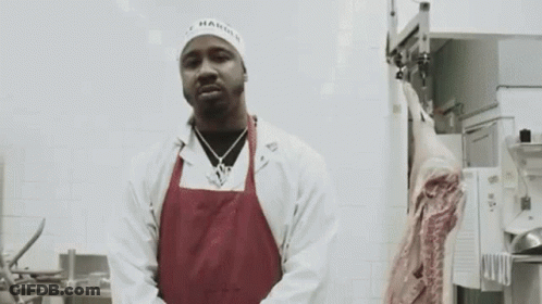 Man In White Coat And Red Apron With Meat GIF