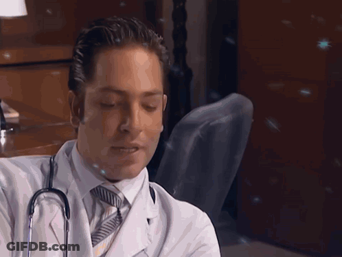 Man In White Coat And Tie Holding Stethoscope GIF