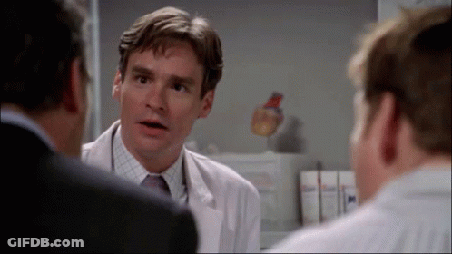 Man In White Coat And Tie Talking To Two Men GIF