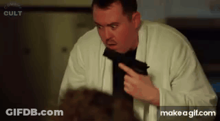 Man In White Coat Pointing Gun At Another Man GIF