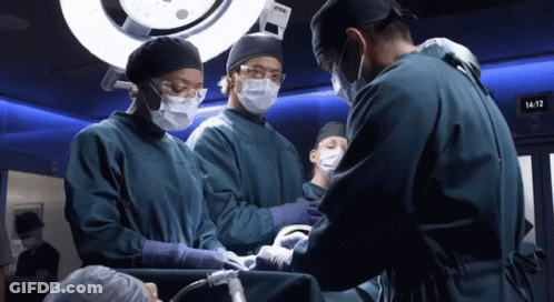 Man In White Coat Standing In Hospital Hallway GIF