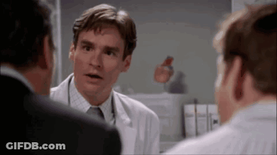 Man In White Coat Talking To Two Men GIF