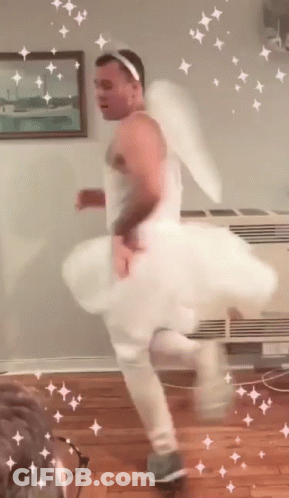 Man In White Dress And Angel Wings Dancing GIF