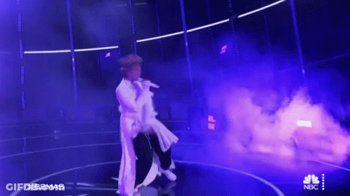 Man In White Dress Singing Stage Purple Smoke GIF