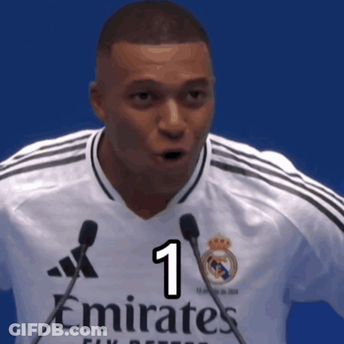 Man In White Emirates Jersey Holding Two Microphones GIF