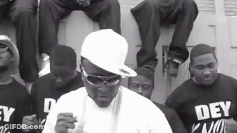 Man In White Hat And Sunglasses With Group Saying Dey Kno GIF